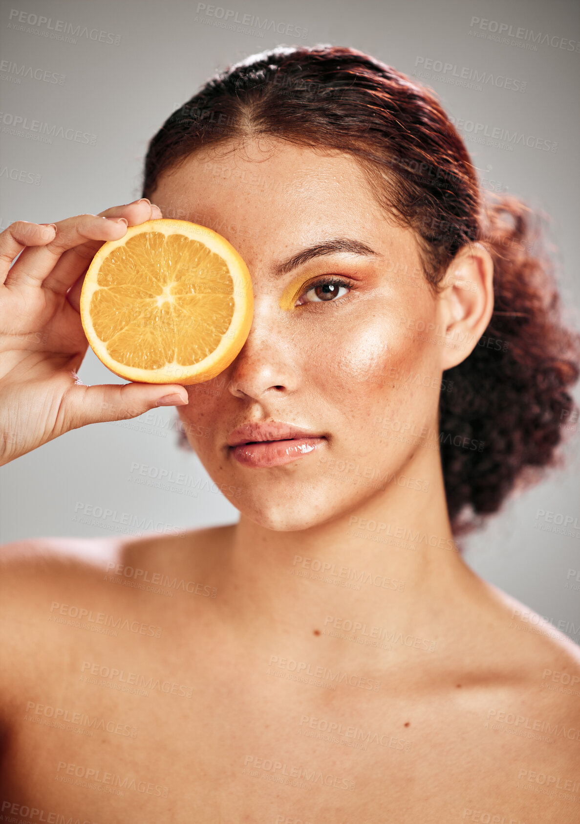 Buy stock photo Woman, orange eye and face portrait in studio for natural skin glow, cosmetics and dermatology. Facial makeup, health and wellness of aesthetic model person with vitamin c skincare fruit results
