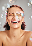 Bubbles, happy face and beauty woman in studio for skincare cosmetics, natural skin and dermatology. Facial makeup, health and wellness of comic model person with luxury body product glow and peace
