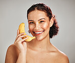 Beauty, face portrait and happy woman with banana for facial skincare glow, fruit detox or natural makeup girl. Wellness health product, nutritionist food or model smile isolated on studio background