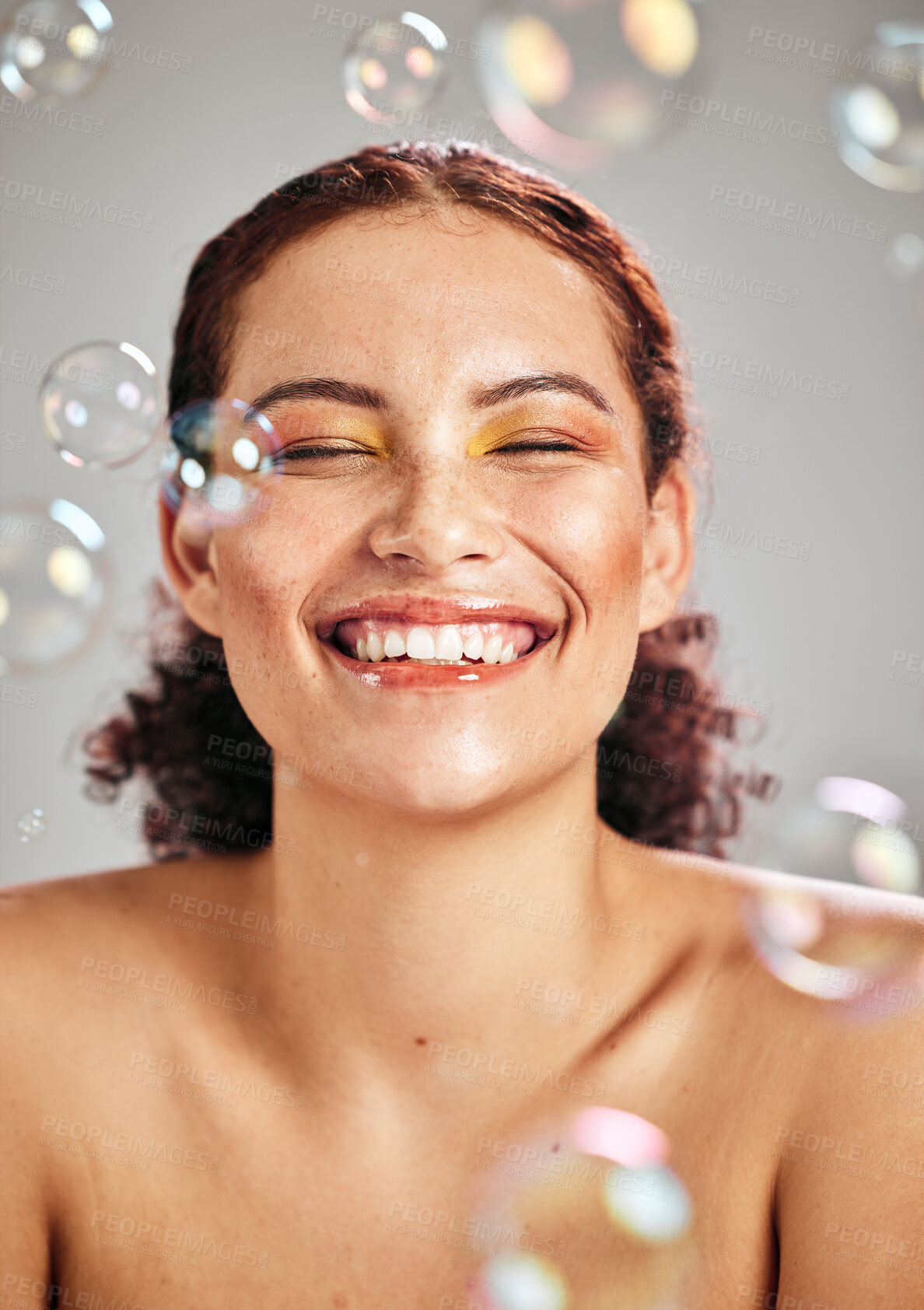 Buy stock photo Beauty, bubbles and face of woman with a smile in studio for skincare cosmetics, skin glow and dermatology. Natural facial makeup, health and wellness of aesthetic model with luxury body product
