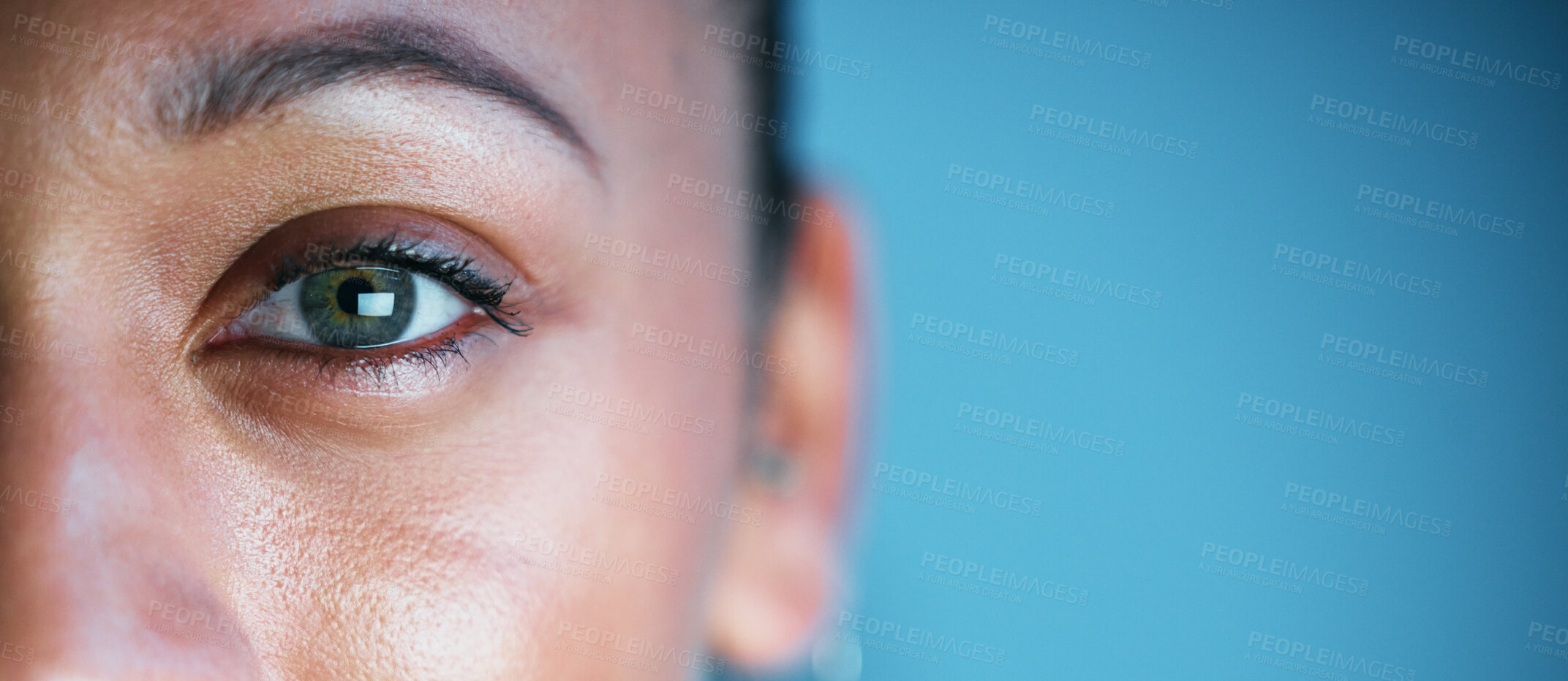 Buy stock photo Eye, face and mockup with woman in portrait, vision and eye care with ophthalmology isolated on blue background. Eyebrow, future and perception, contact lens and lashes, awareness and focus in studio
