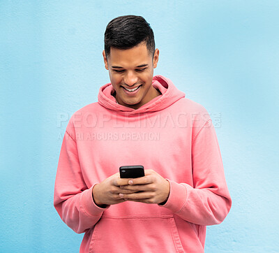 Buy stock photo Happy man, fashion or phone typing on isolated blue background in Brazil city on social media, app or internet. Smile, person or student model on mobile communication technology by urban wall mock up