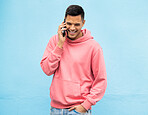 Casual man, phone and laughing on call in communication standing isolated on a blue background. Happy male, person or guys with pink jacket in discussion, conversation or talking on mobile smartphone