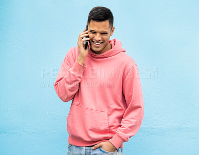 Buy stock photo Casual man, phone and laughing on call in communication standing isolated on a blue background. Happy male, person or guys with pink jacket in discussion, conversation or talking on mobile smartphone