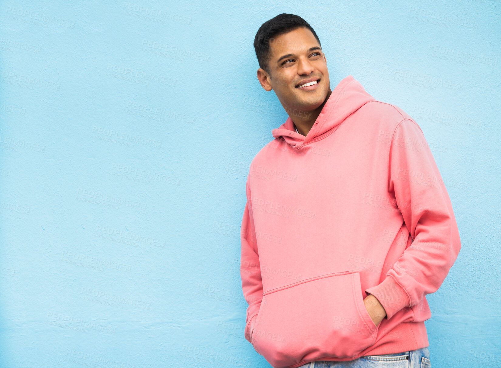 Buy stock photo Happy, casual and man in studio thinking, relax and normal against a blue background space. Laugh, contemplation and  chilling Mexican man standing against mockup, real and cheerful while isolated