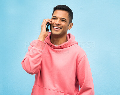 Buy stock photo Casual man, phone call and smile for communication standing isolated on a blue background. Happy male, person or guys with pink jacket in discussion, conversation or talking on mobile smartphone