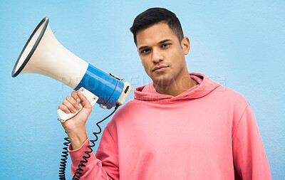 Buy stock photo Man, portrait or megaphone for protest, human rights equality or freedom campaign on isolated blue background. Student, person or model with loud speaker for empowerment speech, justice or revolution