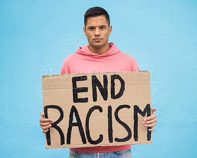 Buy stock photo Portrait, sign and racism with a man in studio on a blue background for freedom at a march or rally.  Government, politics and justice with a male protestor holding a for protest or equality