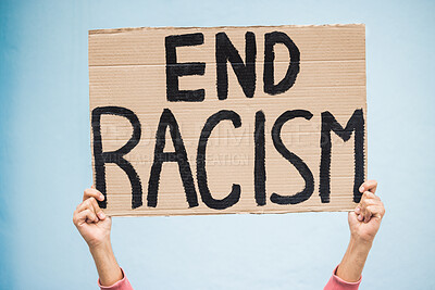 Buy stock photo Hands, cardboard poster and end racism for protest, march or community advertisement against studio background. Hand of activist holding billboard, banner or sign for equality, message or protesting