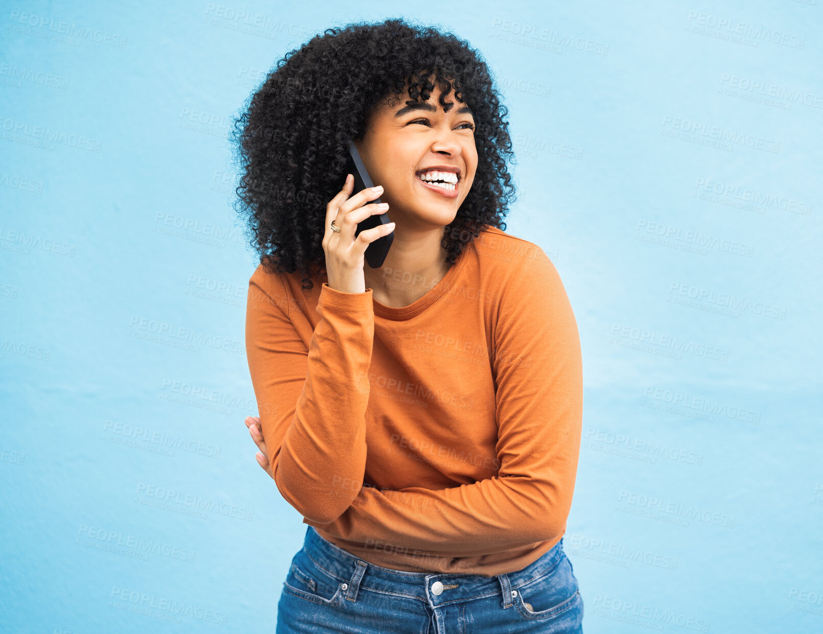 Buy stock photo Laughing black woman, afro and phone call on isolated blue background for funny gossip, comedy news or comic story. Smile, happy and student talking on mobile communication technology by wall mock up