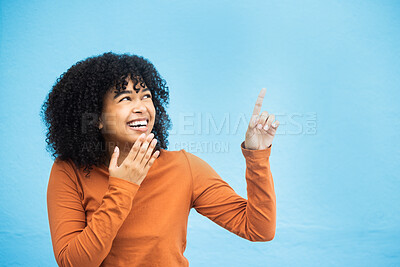 Buy stock photo Black woman, wow face and pointing hands in studio for news, announcement or notification by blue background. African gen z girl, young model and fashion with surprise hand sign with excited laugh