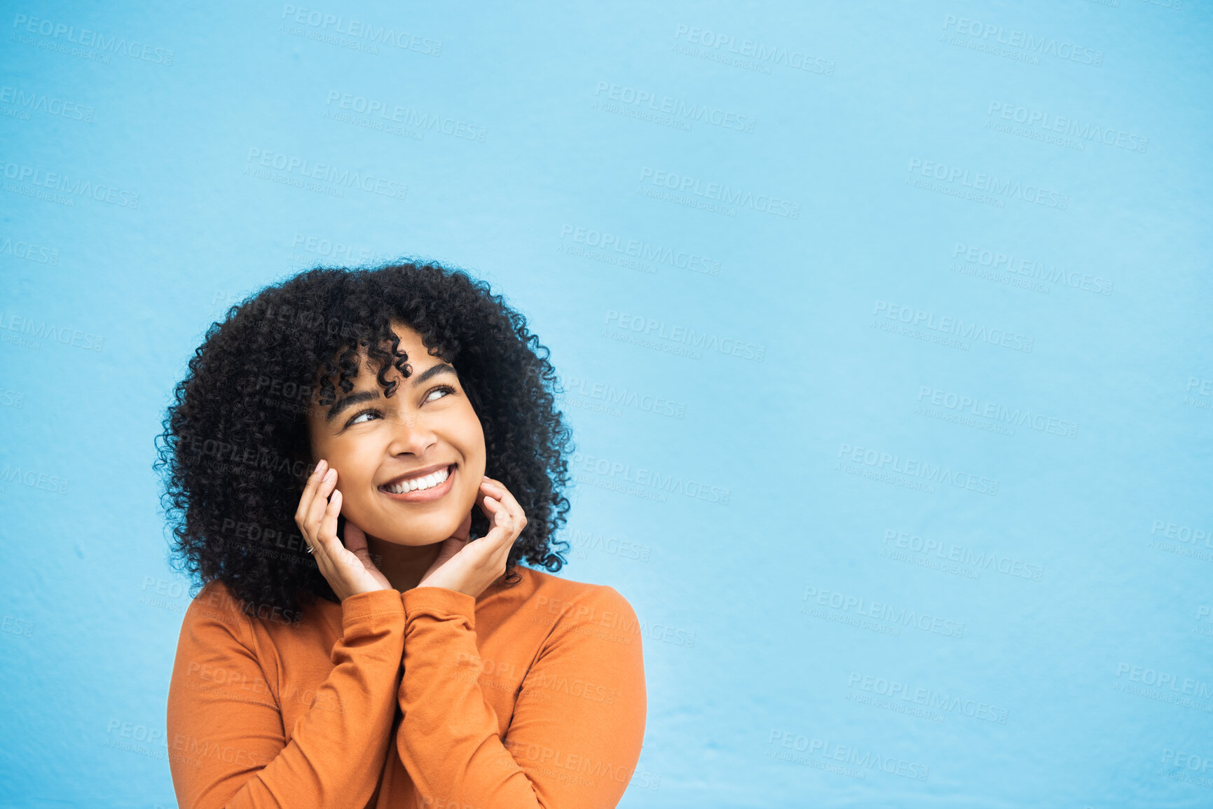 Buy stock photo Thinking, happy and mockup with a black woman on a blue background in studio for branding or product placement. Idea, smile and mock up with an attractive young female looking thoughtful on space