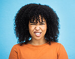Portrait, emoji and woman with facial expression in studio for fun, relax and playful attitude on blue background. Face, comic and goofy black woman with a funny face, crazy and personality isolated
