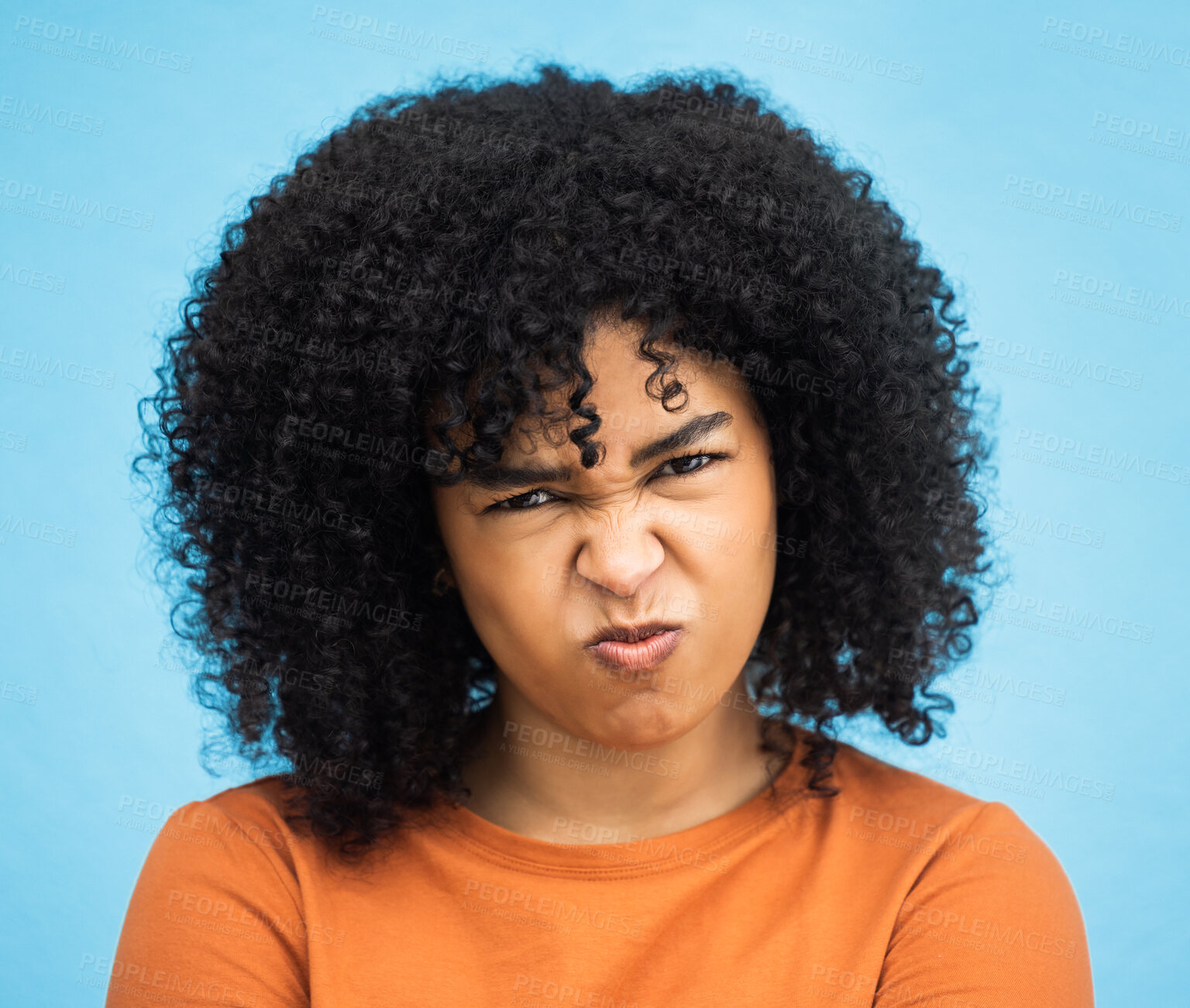 Buy stock photo Black woman, portrait or angry facial expression on isolated blue background in mental health burnout. Headshot, model or person with mad, annoyed or frustrated face on backdrop mockup with afro hair