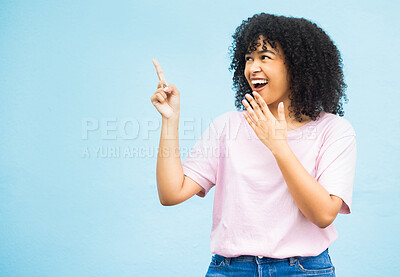 Buy stock photo Mock up, surprise or happy black woman point at sales promo, discount gift deal or marketing space gesture. Wow, product placement mockup or female advertising girl isolated on blue background studio