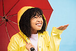 Black woman, umbrella or hand catching rain on isolated blue background in Brazil city. Person, student or checking for weather water drops in rainfall anxiety, curious or wondering facial expression