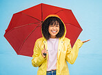 Black woman, portrait and rain umbrella and hand checking for drops on isolated blue background in Brazil city. Happy person, student and raincoat for weather protection, rainfall water or insurance