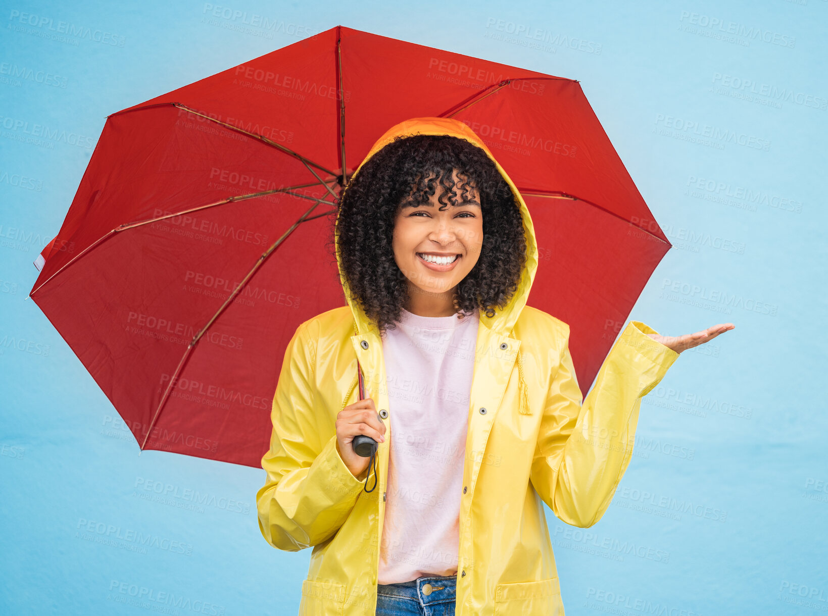 Buy stock photo Black woman, portrait and rain umbrella and hand checking for drops on isolated blue background in Brazil city. Happy person, student and raincoat for weather protection, rainfall water or insurance