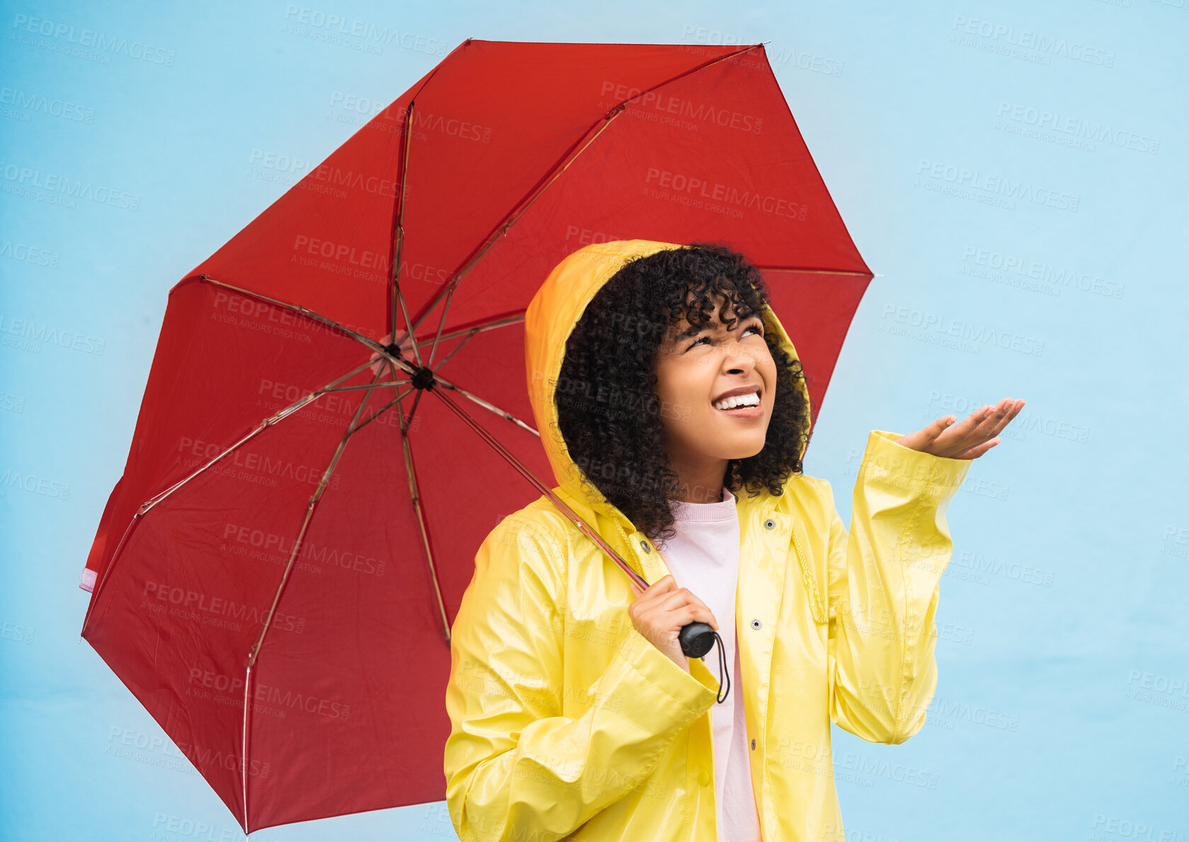Buy stock photo Black woman, umbrella or hand checking for rain on isolated blue background in Brazil city. Person, anxiety or student in weather water drops or rainfall with curious or wondering facial expression