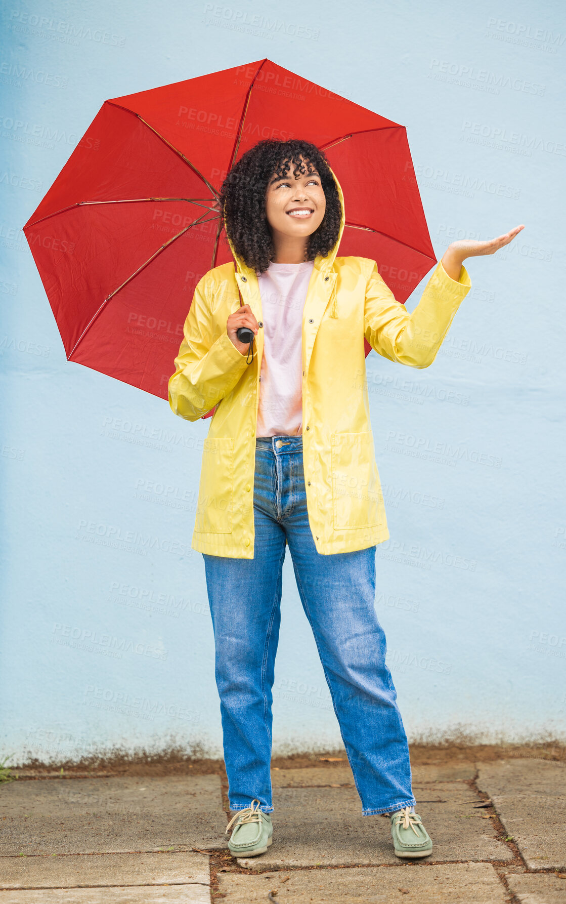 Buy stock photo Rain, black woman and umbrella in a city for travel, having fun and solo trip on wall background. Weather, happy and girl traveler enjoying rainfall, happy and smile for journey, experience and joy