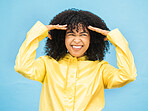 Face, thinking and laugh with a black woman on a blue background in studio for fun or laughter. Idea, joy and humor with an attractive young afro female laughing on a color wall for enjoyment