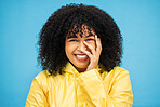 Portrait, laugh and funny with a black woman on a blue background, laughing at a joke in studio. Face, happy and smile with an attractive young afro woman enjoying humor or fun against a color wall