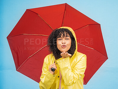 Buy stock photo Woman, portrait or blowing kiss and rain umbrella on isolated blue background in Brazil city love or support. Black person, raincoat or flirty student and facial expression or water weather insurance
