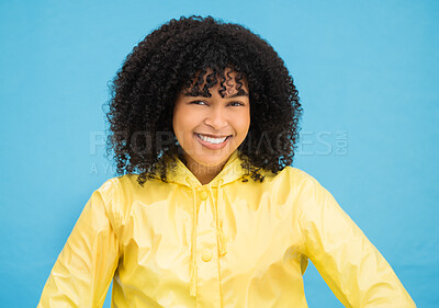 Buy stock photo Black woman, smile and happy in portrait with fashion for winter, rain coat and beauty isolated on blue background. Happiness in studio, style and success with mockup, trendy and female headshot