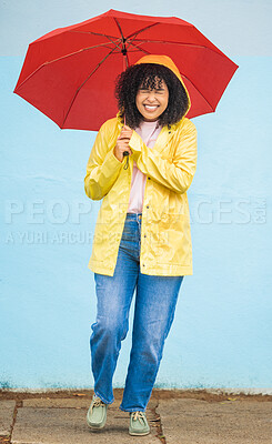 Buy stock photo African woman, smile and umbrella by wall with excited face, rain and fashion raincoat in funny moment in city metro. Gen z girl, winter or comic laughing for weather, walk or urban outdoor adventure