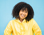 Woman, smile and happy in portrait with fashion for winter, rain coat and beauty isolated on blue background. 
African person, happiness in studio and style with success, mockup and trendy headshot