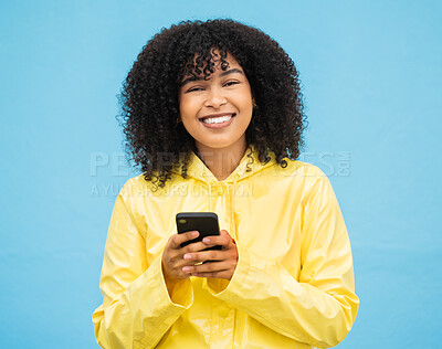 Buy stock photo Black woman, portrait and phone with a person smile with blue studio background, Isolated, happiness and social media mobile communication of a female ready to text and connect on a cellphone