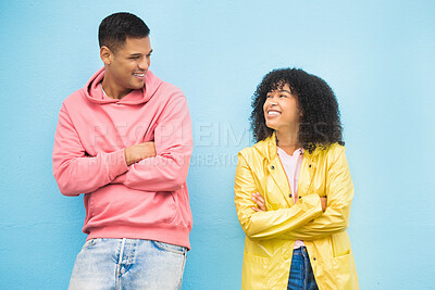 Buy stock photo Couple of friends, happy and arms crossed on isolated blue background in city bonding, support and fun city travel. Smile, happy man or black woman and confidence, afro hair or fashion clothes mockup