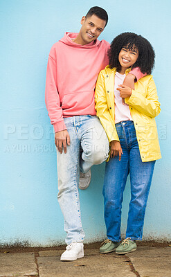 Buy stock photo Couple of friends, bonding or hug portrait on isolated blue background in fashion, afro hair trend or cool style clothes. Smile, happy man or black woman in embrace on mock up backdrop in Brazil city