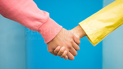 Buy stock photo Couple, love and holding hands together for support care, relationship and bonding in blue background studio. Man, woman and hand for partnership, romance trust and solidarity or compassion lifestyle