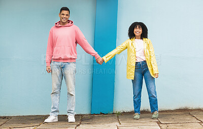 Buy stock photo Happy couple, love portrait and holding hands together for support care, relationship and bonding in urban town. Man, woman smile and partnership hand, romance and solidarity or compassion lifestyle