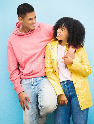 Buy stock photo Couple of friends, bonding and hug on isolated blue background in fashion, afro hair trend and cool style clothes. Smile, happy man and black woman in embrace on wall mock up backdrop in Brazil