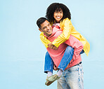 Happy couple, bonding or piggyback on isolated blue background in city travel, date or fun game. Smile, happy or man carrying black woman in silly, goofy or playful activity in trust, support or love