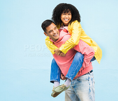 Buy stock photo Happy couple, bonding or piggyback on isolated blue background in city travel, date or fun game. Smile, happy or man carrying black woman in silly, goofy or playful activity in trust, support or love