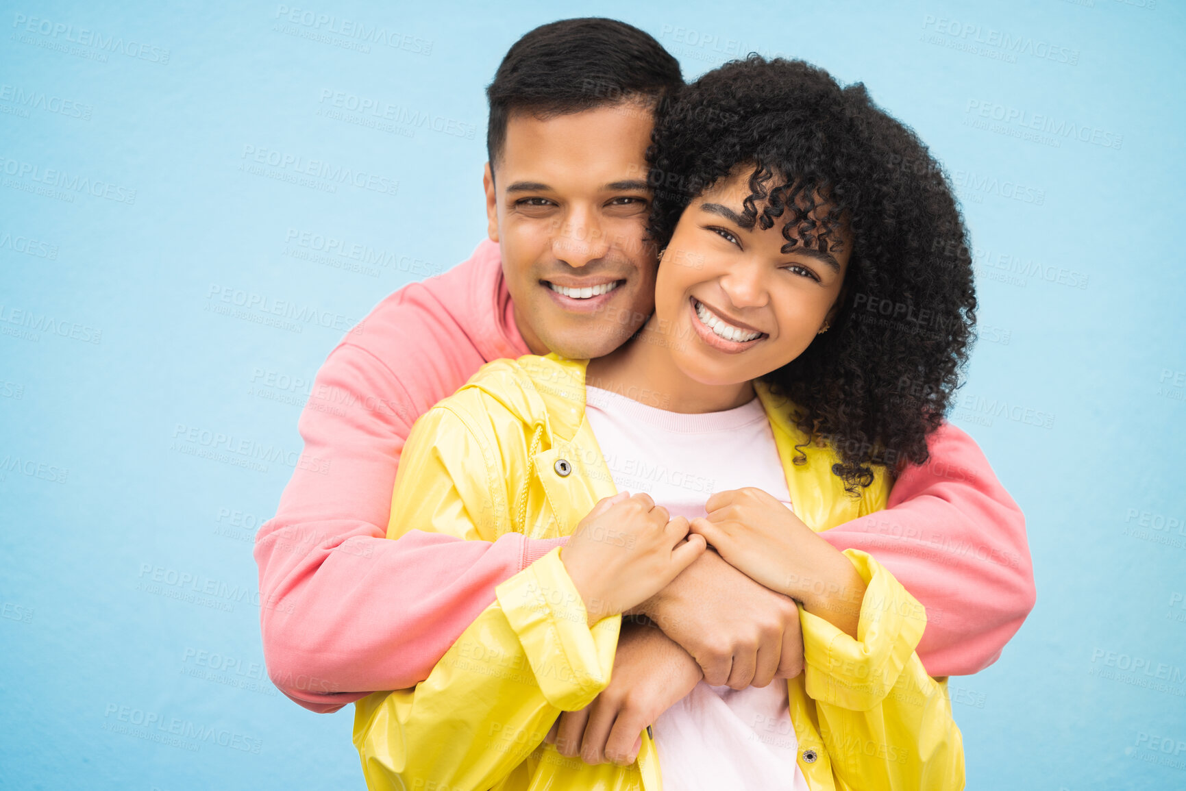 Buy stock photo Happy people, smile and hug in portrait with couple in love, commitment isolated on blue background. Interracial relationship mockup, commitment and together in studio with black woman, man and trust