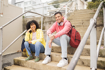 Buy stock photo Portrait, stairs and students with a man and black woman sitting outdoor on campus together at university for education. Scholarship, college and school with a male and female pupil seated on steps