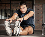 Portrait, fitness and stretching with a man athlete in gym getting ready for his workout routine. Exercise, health and warm up with a handsome young male training in a performance center for wellness