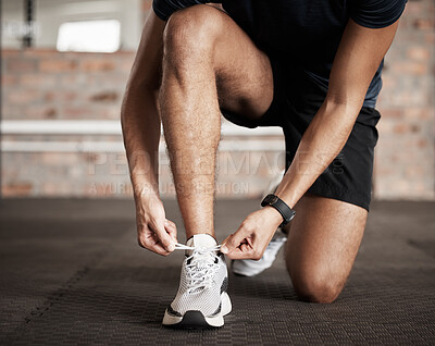 Buy stock photo Fitness, man and tying shoe lace getting ready for running exercise, workout or training at gym. Sporty male, person or guy shoes in preparation for sport run, cardio or warm up on floor at gymnasium
