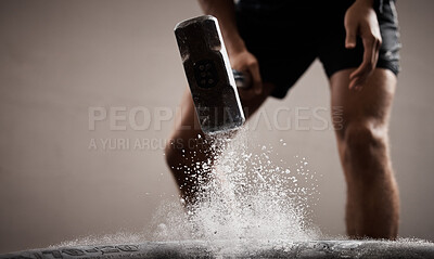 Buy stock photo Workout, dust and hands hammer tire in studio isolated on a brown background mockup. Sports, fitness and male, athlete or man hammering tyre with chalk powder for training, exercise and muscle power.