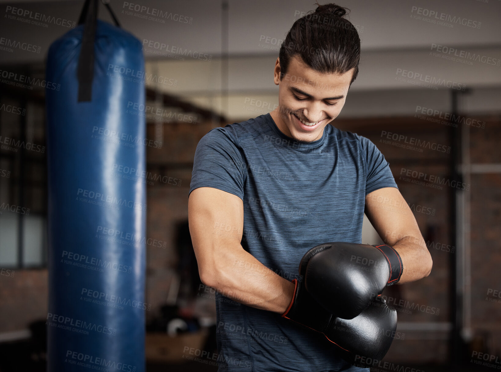 Buy stock photo Fitness, boxing and man with gloves in gym for sport training, exercise or challenge. Happy, smile and male athlete or boxer doing cardio kickboxing workout for health or wellness in sports studio.
