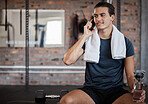 Fitness, man and phone call with water bottle on bench with smile for conversation after workout at gym. Happy sporty male on smartphone in communication while taking a break from intense training
