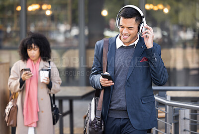 Buy stock photo Businessman, walk in city with music, phone or headphones for audio, chat communication or social media. Corporate man, woman during travel in city with smartphone, typing or reading for networking