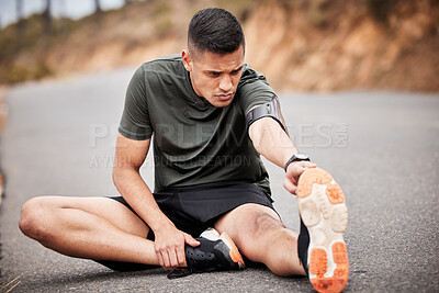 Fitness, man and stretching legs in road for exercise, wellness and marathon training. Sports person, runner and athlete warm up body in street to start cardio workout, performance and healthy goals
