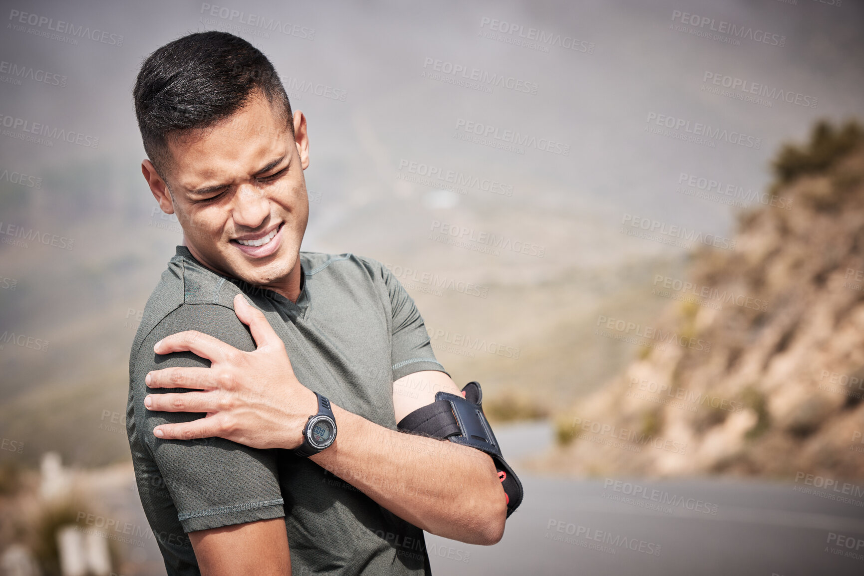 Buy stock photo Fitness, injury and mockup with a sports man holding his shoulder in pain while running outdoor. Medical, exercise and anatomy with a male runner or athlete suffering from a hurt joint while training