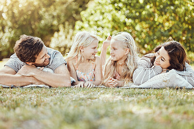 Buy stock photo Family, parents and children lying on grass, park and garden in sunshine together. Kids, mom and dad smile on lawn for love, fun and care in nature, backyard and summer holiday to relax for happiness