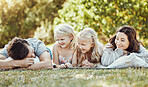 Family, parents and children at park, grass and garden in sunshine. Kids, mom and dad smile on lawn for love, laughing and fun in nature, backyard and summer vacation to relax together with happiness